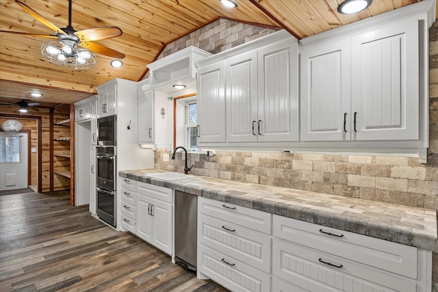 kitchen featuring decorative backsplash, white cabinets, vaulted ceiling, a sink, and wooden ceiling