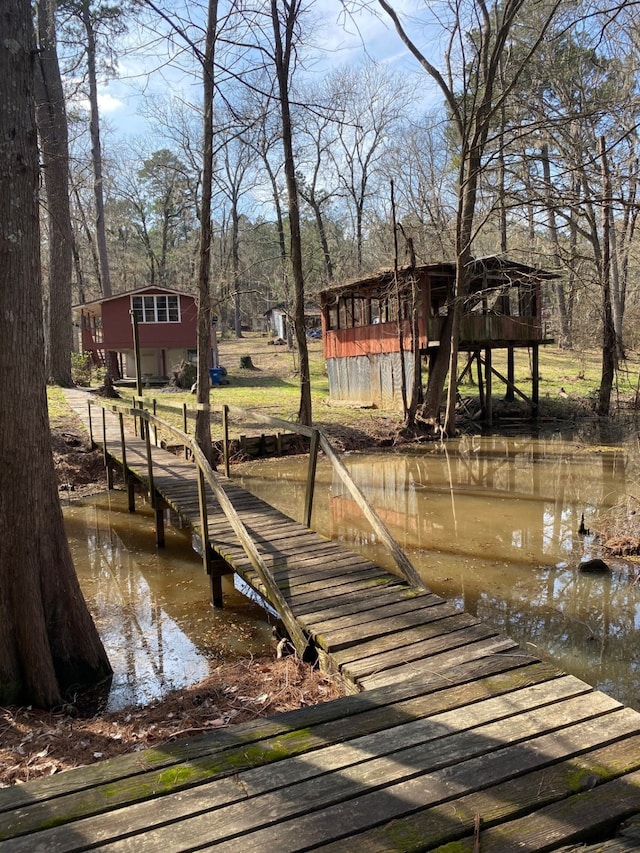 view of dock with a deck with water view