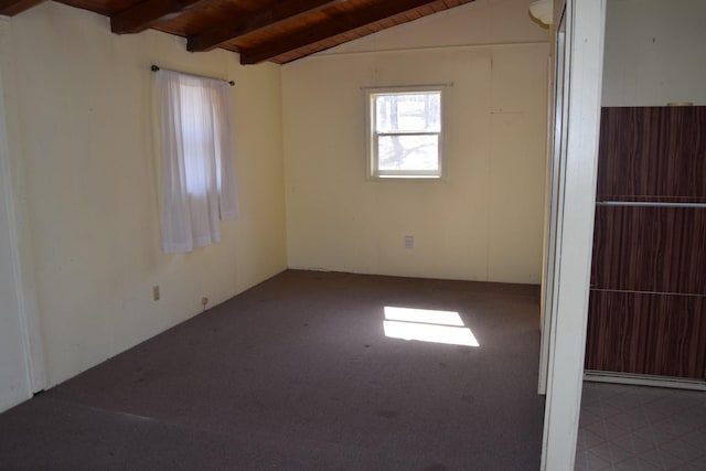 empty room with carpet flooring, wood ceiling, and vaulted ceiling with beams