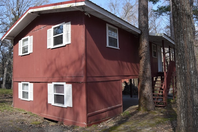 view of side of property featuring stairs