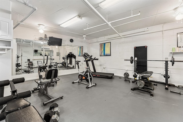 workout area featuring concrete block wall