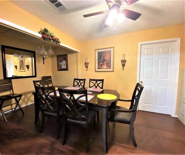 dining area with a textured ceiling, ceiling fan, and visible vents