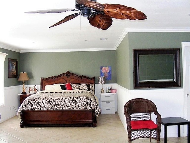 bedroom featuring wainscoting, visible vents, crown molding, and ceiling fan