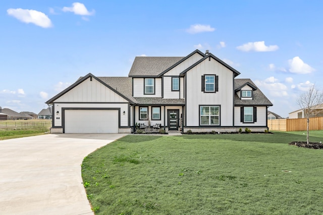 modern farmhouse featuring a garage, fence, driveway, board and batten siding, and a front yard