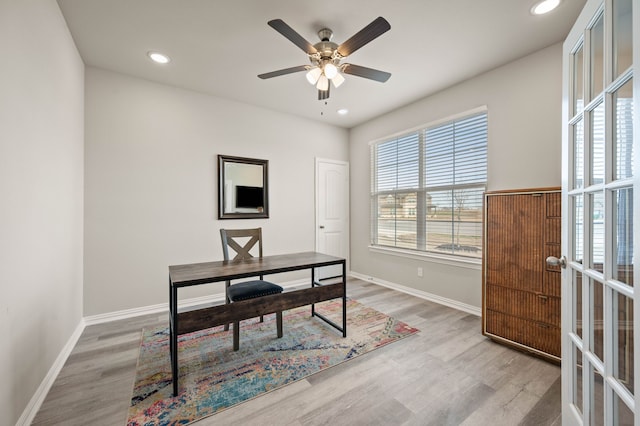 office space featuring french doors, light wood-type flooring, and baseboards