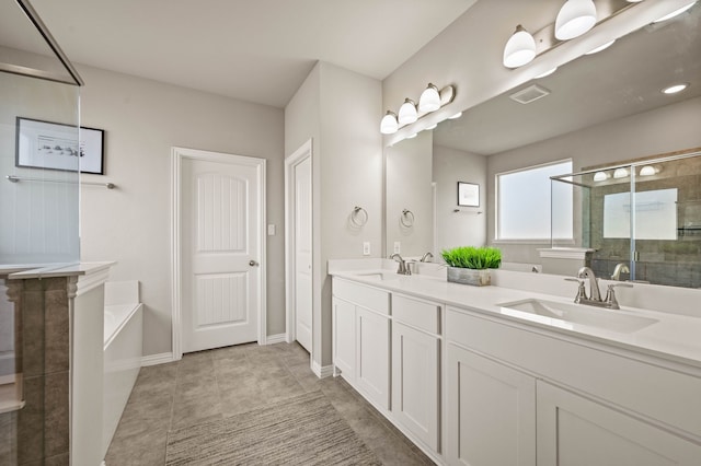 bathroom with double vanity, a stall shower, visible vents, a sink, and a bath