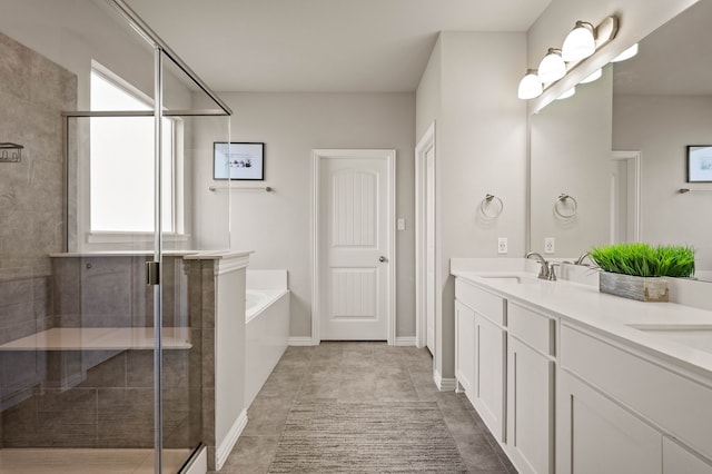 bathroom with a shower stall, a sink, and a healthy amount of sunlight