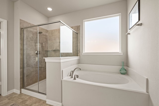 full bath featuring a stall shower and a garden tub