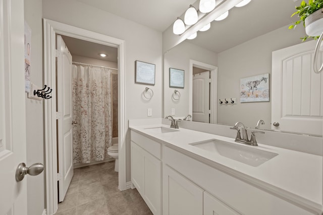 bathroom with tile patterned floors, a sink, toilet, and double vanity