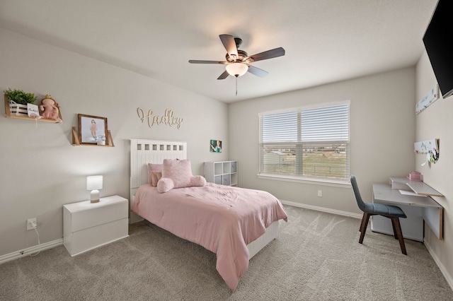 bedroom with a ceiling fan, light colored carpet, and baseboards