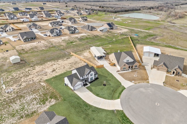 drone / aerial view featuring a water view and a residential view