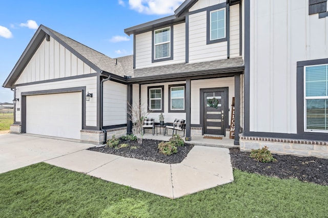 view of front of property featuring a porch, a shingled roof, an attached garage, board and batten siding, and driveway