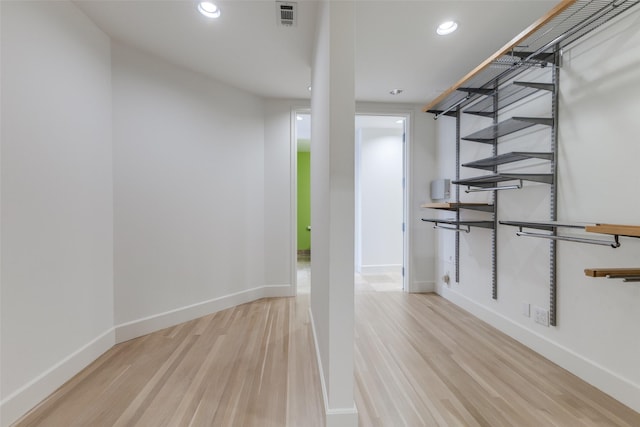 interior space featuring visible vents, baseboards, wood finished floors, and recessed lighting