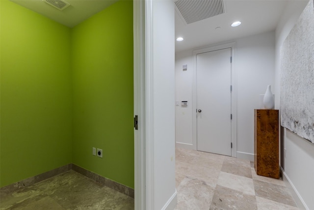 hallway featuring baseboards, visible vents, and recessed lighting