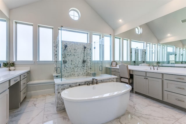 bathroom with marble finish floor, a shower stall, and a healthy amount of sunlight