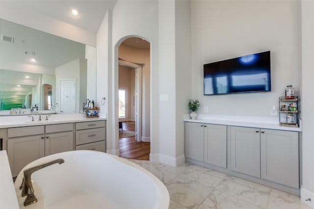 full bath with baseboards, visible vents, recessed lighting, a freestanding bath, and marble finish floor