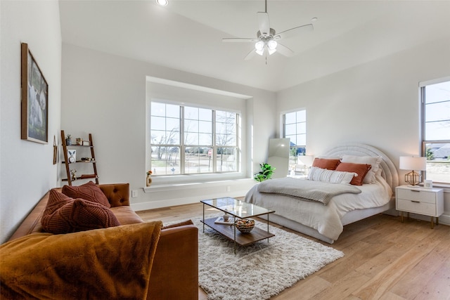 bedroom with light wood-style flooring, multiple windows, and baseboards