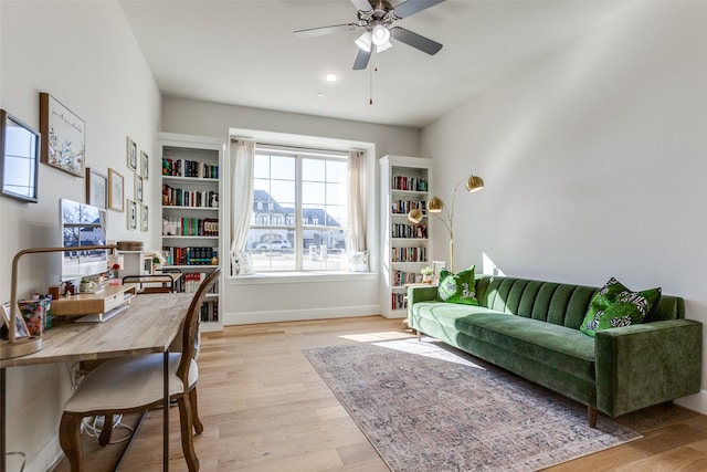 office featuring ceiling fan, baseboards, and light wood-style flooring