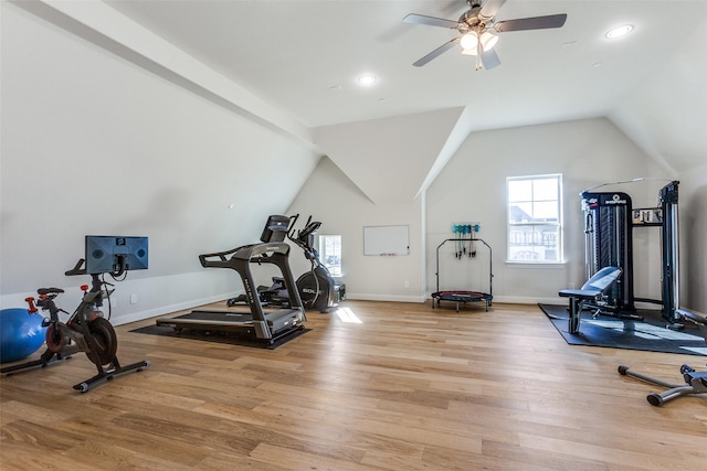 workout area with vaulted ceiling, light wood-style flooring, a ceiling fan, and baseboards