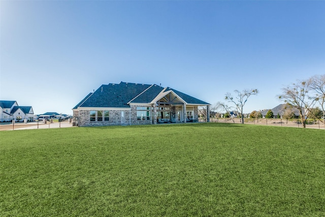 view of front of house with stone siding and a front yard