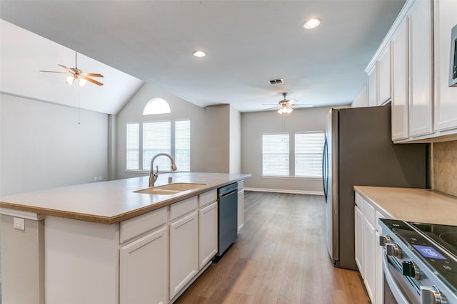 kitchen with dishwasher, white cabinets, a sink, and stainless steel range with electric cooktop