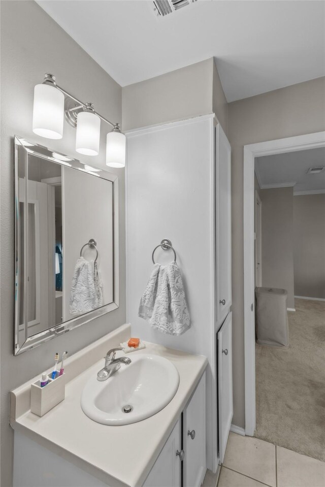 bathroom featuring visible vents, vanity, and tile patterned floors