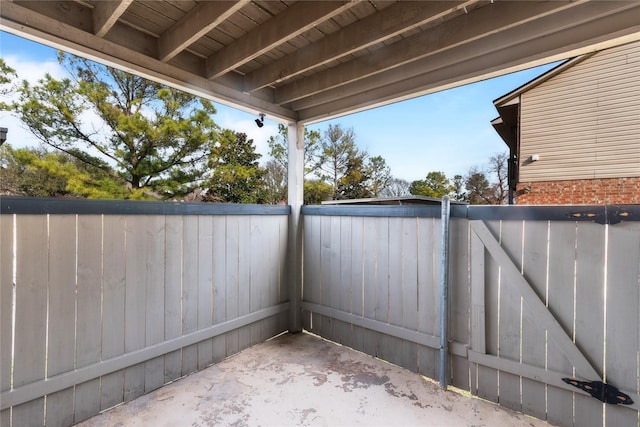 view of patio featuring a gate and fence