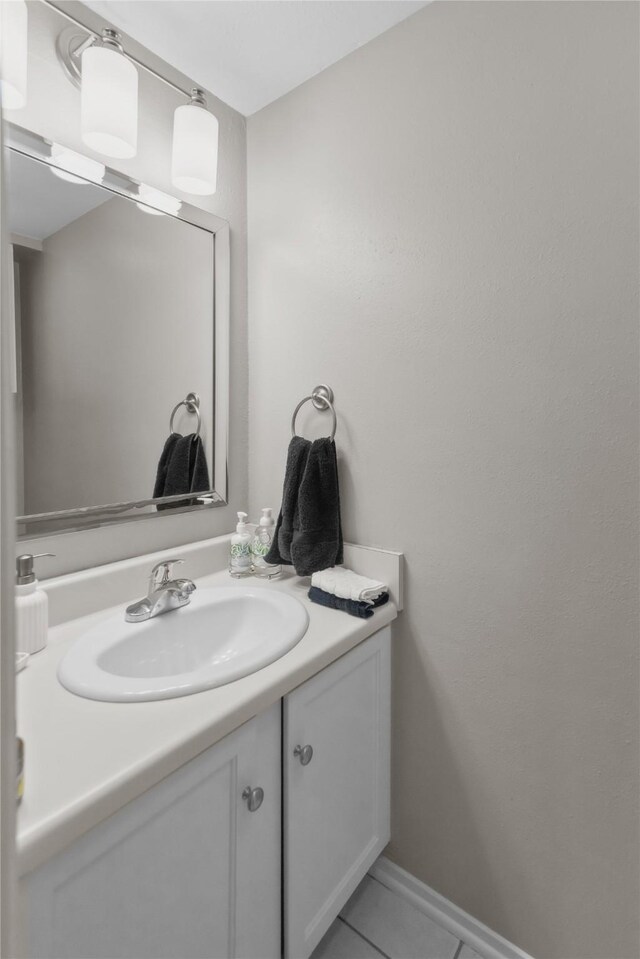 bathroom featuring tile patterned flooring, vanity, and baseboards