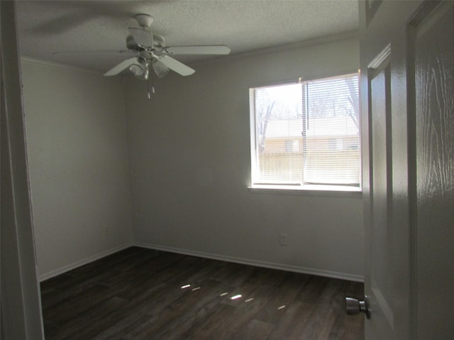 unfurnished room with a textured ceiling, dark wood-type flooring, crown molding, and baseboards