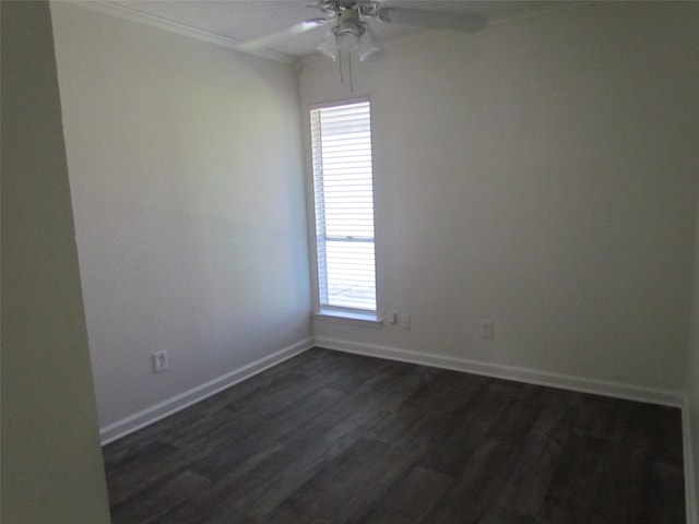 unfurnished room with dark wood-style floors, baseboards, a ceiling fan, and ornamental molding