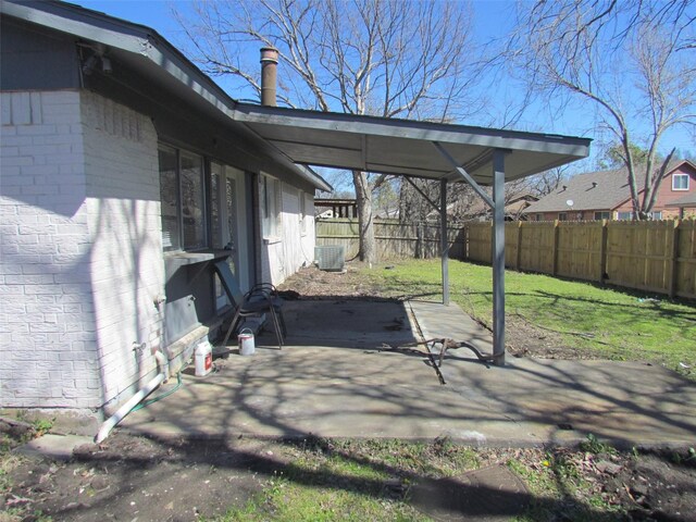 view of patio with a carport and a fenced backyard