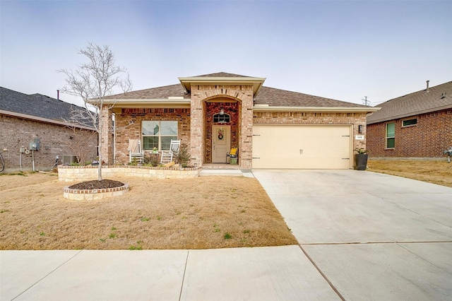 view of front of home with concrete driveway, brick siding, roof with shingles, and an attached garage