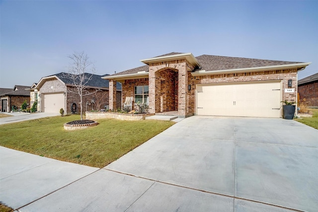 view of front of home with an attached garage, a shingled roof, a front lawn, brick siding, and driveway