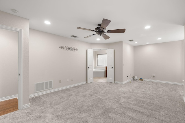 interior space with recessed lighting, carpet flooring, visible vents, and baseboards