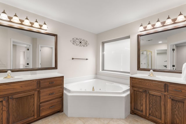 bathroom featuring a whirlpool tub, a stall shower, two vanities, and a sink