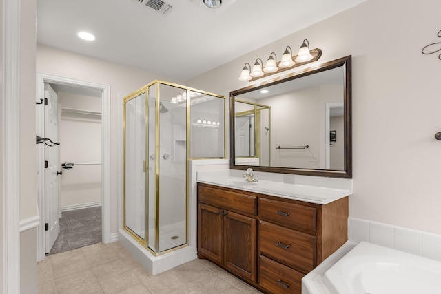 bathroom with a stall shower, visible vents, a bathing tub, tile patterned flooring, and vanity