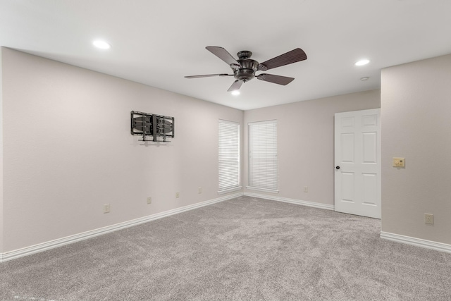 carpeted empty room featuring ceiling fan, baseboards, and recessed lighting