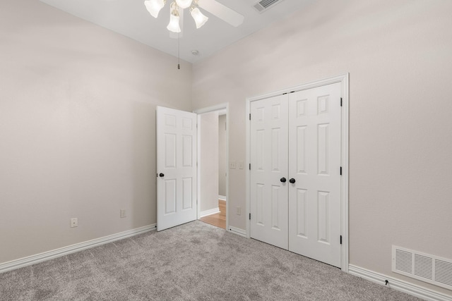 unfurnished bedroom with a closet, carpet, visible vents, and baseboards