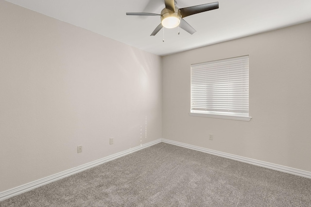 spare room featuring carpet flooring, a ceiling fan, and baseboards