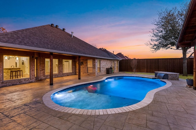 pool at dusk featuring a fenced in pool, a fenced backyard, a patio, and central air condition unit