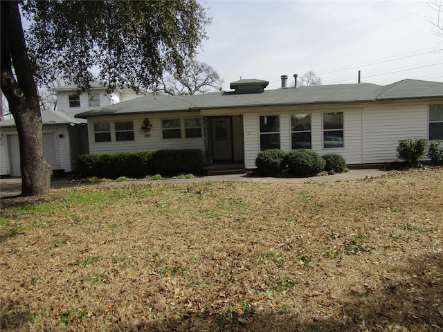 single story home featuring a garage and a front lawn