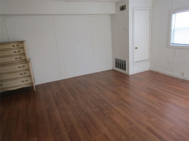 unfurnished bedroom with visible vents and wood finished floors