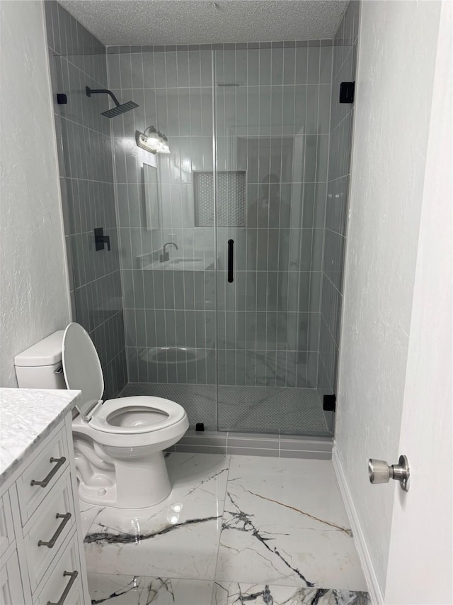 bathroom featuring a stall shower, a textured wall, a textured ceiling, and toilet