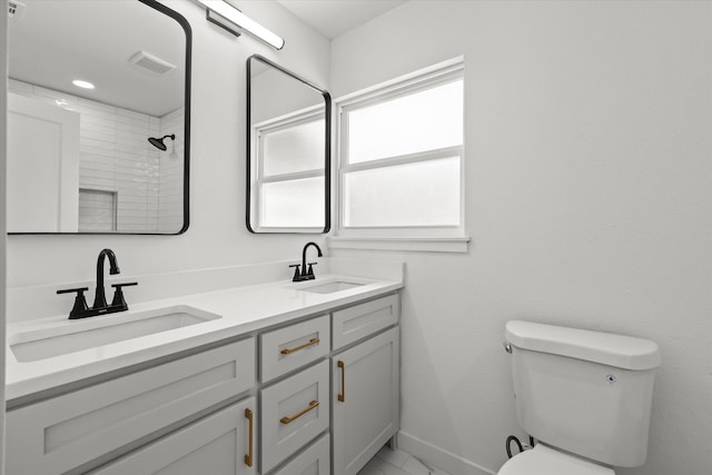 full bathroom featuring toilet, baseboards, marble finish floor, and a sink