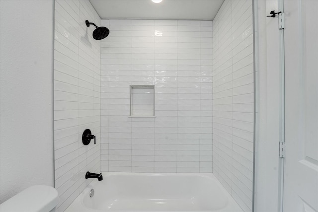 bathroom featuring toilet and shower / bath combination