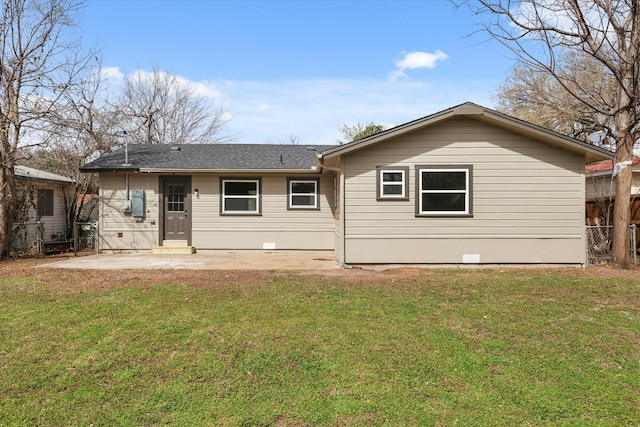 rear view of house with crawl space, a yard, a patio, and fence