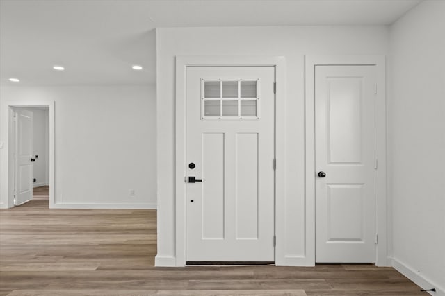 entryway with recessed lighting, light wood-style flooring, and baseboards