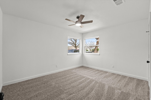 unfurnished room featuring baseboards, visible vents, carpet floors, and ceiling fan