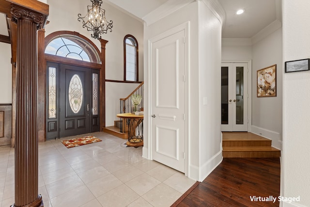 entrance foyer featuring a notable chandelier, recessed lighting, ornamental molding, light wood-style floors, and baseboards