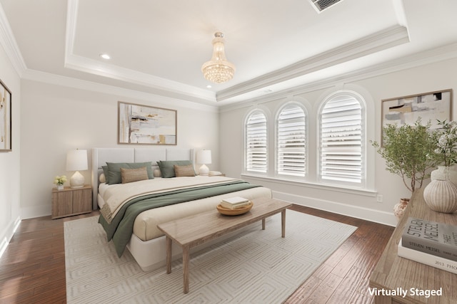 bedroom with ornamental molding, dark wood-type flooring, a raised ceiling, and baseboards